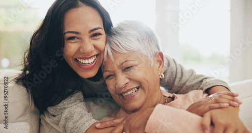 Hug, portrait and smile of old woman with daughter on sofa in living room of home for bonding or visit. Face, family or love with happy person and senior mother embracing in apartment together