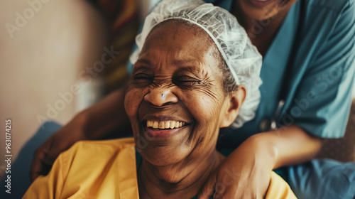 Happy senior black woman in a nursing home. Smiling old african american female pensioner being cared for by a nurse in a hospice for elderly 