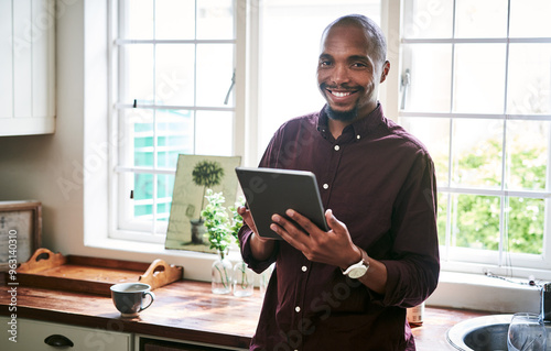 Black man, tablet or portrait in kitchen for remote work, ecommerce or online banking in app. Person, tech or happy in home for email, social media or research job opportunity on internet in Nigeria