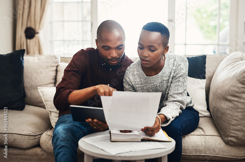 Black couple, home and invoice on sofa with documents for bills, debt and loan interest rate. People, relationship and living room for budget plan or savings with paperwork finances or bank statement