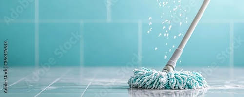 Close-up of soapy water dripping from a mop head as it glides over ceramic tiles, close-up mop with soapy water, bathroom floor cleaning