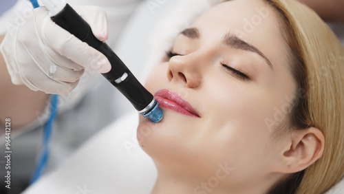 A professional cosmetologist performs hydropeeling and hydrafacial on the client, providing advanced skin care procedures. Ideal for promoting luxury beauty services and enhancing your brand image.