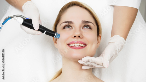 A professional cosmetologist performs hydropeeling and hydrafacial on the client, providing advanced skin care procedures. Ideal for promoting luxury beauty services and enhancing your brand image.