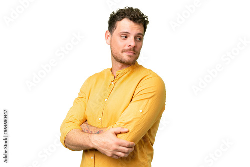 Brazilian man over isolated chroma key background looking to the side