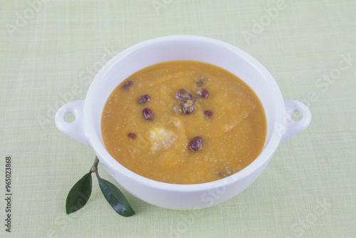 Korean food pumpkin porridge with red beans in a ceramic bowl on cloth, South Korea