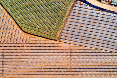 Aerial and top angle view of garlic field with vinyl furrows at a farming village near Muan-gun, South Korea 