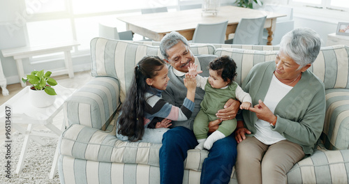 Grandparents, relax and grandchildren on sofa for high five, bonding and family support in living room. Grandma, grandpa and grandkids for love together, people or development in house with fun