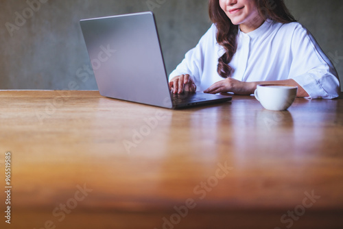 Closeup image of a young woman working on laptop computer