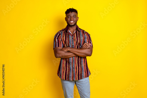 Photo of nice young man folded arms posing wear shirt isolated on yellow color background