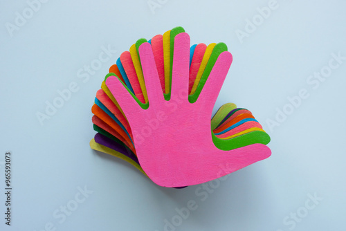 Stack of colorful hands as a symbol of diversity or community support.