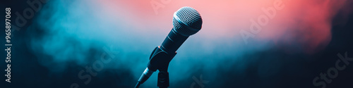 Microphone standing on an empty stage with colorful light and smoke. Mic on a stage