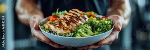 Bowl of grilled chicken and broccoli being offered, a high-protein meal for keto and carnivore diets. Great for weight loss