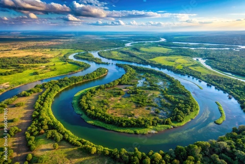 Aerial view of the winding Zambezi River, Africa's fourth-longest river, stretching across Zambia, Angola, Namibia, and Mozambique, featuring lush green forests and vast wetlands.