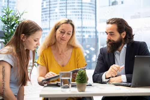 Financial advisor talking with clients, recommending optimal financial services and investments. Agent informing and showing mother and young adult of best investment strategies