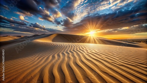 Sand dune at sunset with beam of light on immaculate pattern