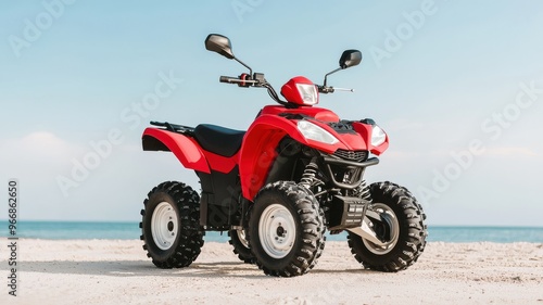 A vibrant red quad bike parked on a sandy beach with a clear blue sky in the background, ideal for outdoor adventure themes.