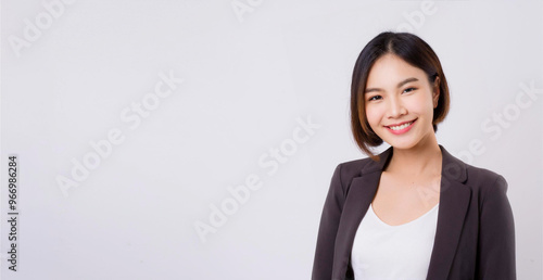 A portrait of a Southeast Asian female businessperson with short hair, wearing a jacket.