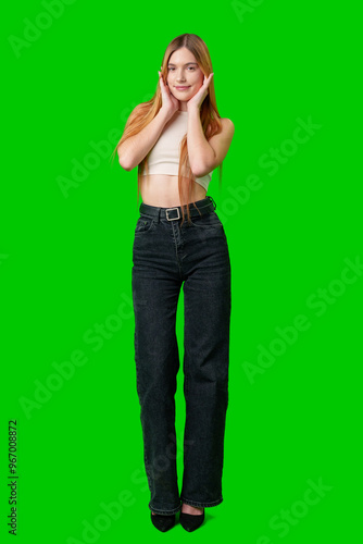 Young Woman With Long Red Hair Smiles in Front of Green Screen