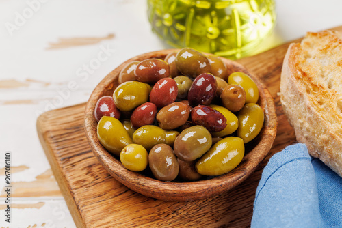 An assortment of various olives presented in a bowl, showcasing different colors, textures, and flavors