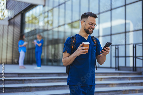 Smiling Male Nurse Using Smartphone Outdoors at Hospital