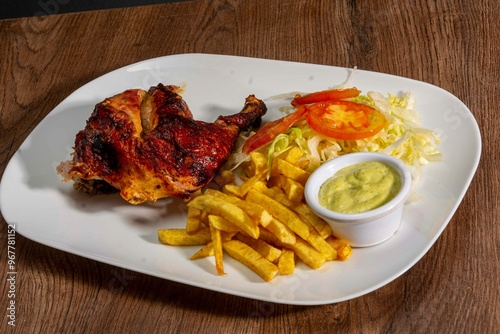 Deliciously charred and smoky Pollo a la Brasa (grilled chicken) served whole and in pieces, accompanied by crispy fries, fresh salad, and a flavorful dipping sauce. A classic Latin American dish, coo