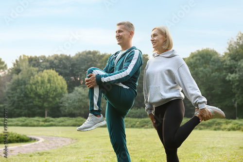 Happy couple doing exercises in park. Healthy lifestyle