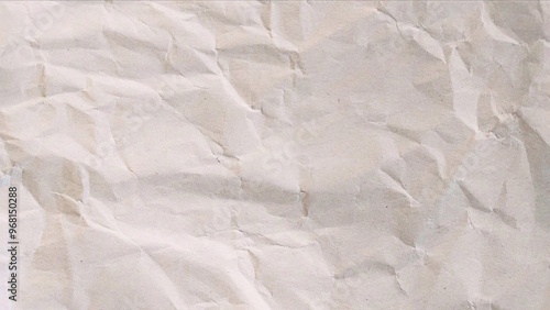 neutral light crumpled paper background texture. wrinkled creased sheet