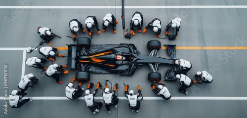 Formula 1 pit crew in uniforms surrounds a racing car, performing a pit stop with precision and speed.