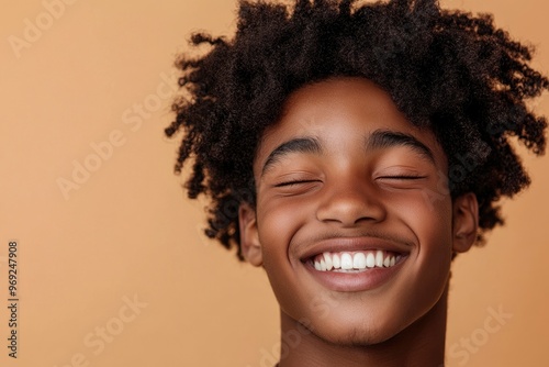 Happy young African American gen z guy winking isolated on beige background. Playful ethnic teen student, cool curly generation z teenager smiling with white perfect teeth, with generative ai