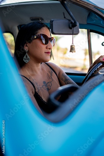 Young woman driving a vintage blue car