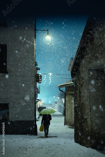 Person walking in the city during a snowfall on New Years Eve, moody ambience, Aprica, Northern Italy