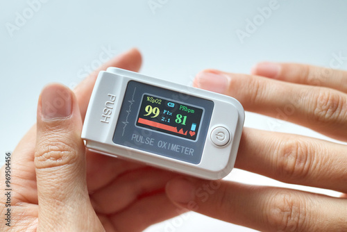 Accurate measurement of vital signs. Anonymous female using medical professional digital pulse oximeter to check oxygen level and heart rate through her fingertip