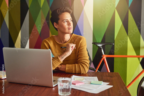 Woman, thinking and creative with laptop for web design, planning or research and development at office. Young, female person or designer in wonder, thought or contemplating for decision at workplace