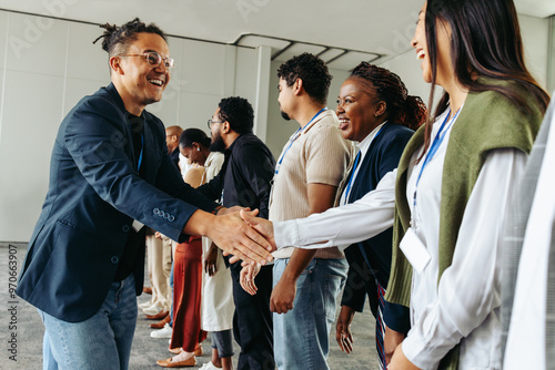 Business professionals shaking hands and networking in an office setting