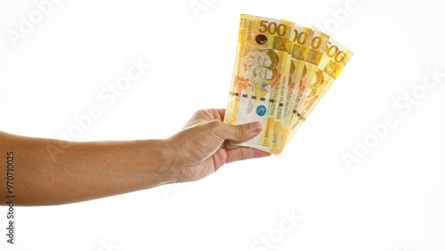 Hand holding philippine pesos on an isolated white background showcasing money in the philippines.