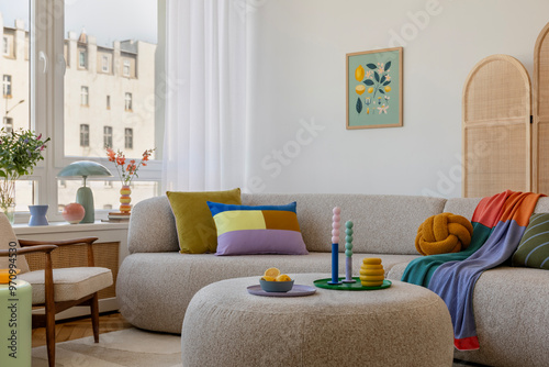 Stylish living room with a round ottoman, fresh floral arrangements, and colorful decor, creating a lively yet cozy atmosphere. Home decor and mock up poster frame.