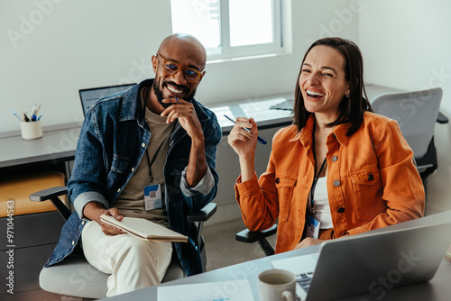 Happy co-workers smiling and collaborating in a positive office culture