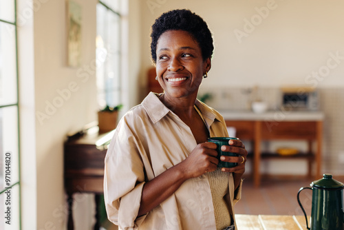 Mature Brazilian woman enjoying morning cafézinho at home