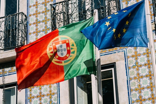 Portuguese and European Union flags waving proudly in a traditional Lisbon setting adorned with colorful tiles