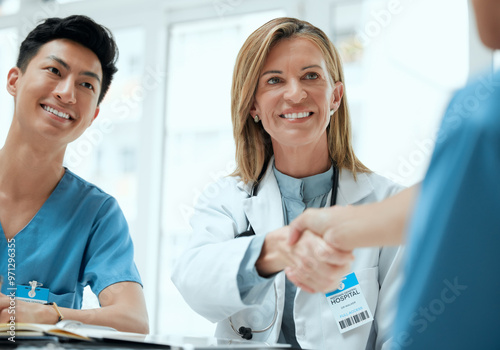 People, doctor and nurse with hand shake at boardroom for welcome and congratulations on internship. Employees, office and happy or smile with greeting for job interview, opportunity and recruitment