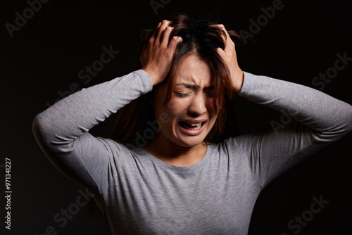 Woman, anxiety and panic with fear for abuse, mental illness or disorder in studio on a black background. Female person, psychosis or paranoid model in frustration with anxiety, depression or stress