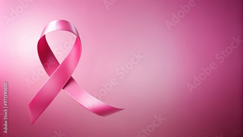 A pink awareness ribbon on a soft pink background, symbolizing the fight against breast cancer and promoting hope and support.