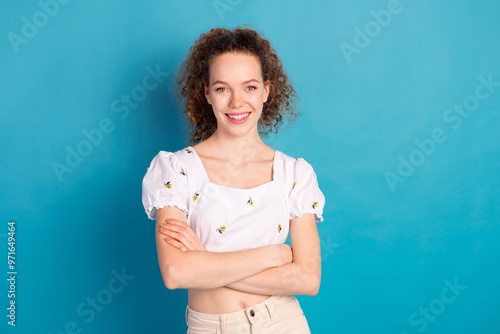 Photo portrait of lovely young lady crossed hands confident dressed stylish white garment isolated on blue color background