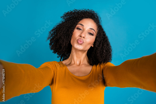 Photo portrait of nice young lady take selfie photo kissing lips dressed stylish yellow garment isolated on blue color background