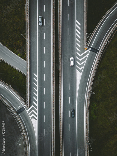 Aerial drone view of highway road intersection with cars in Italy