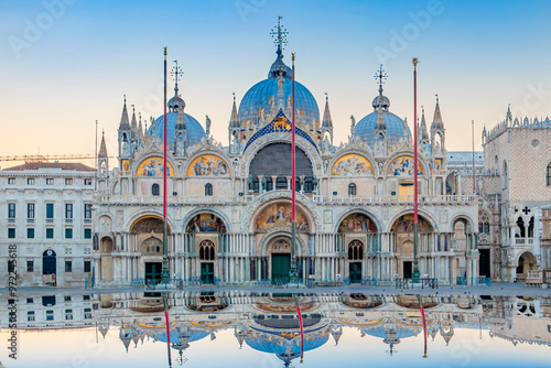 Sunrise in San Marco square with Campanile and San Marco's Basilica. The main square of the old town. Venice, Veneto Italy. Reflection on the flooded square.