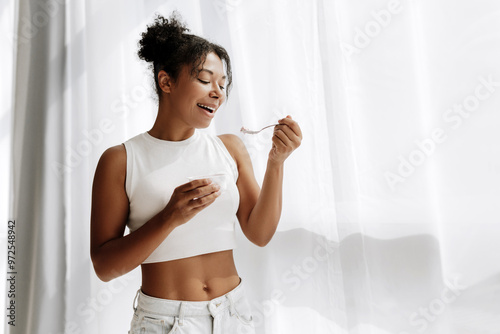 Beautiful black woman enjoying a healthy breakfast at home