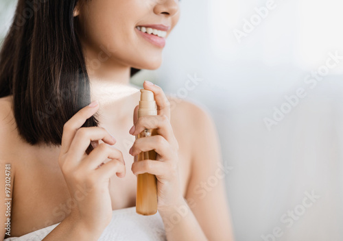 Hair products. Closeup of unrecognizable asian girl using hair spray, copy space