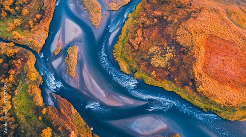 A drone captured a stunning aerial view of the meandering Holtsa River in Iceland. The river's twists and turns create intricate patterns against the vibrant landscape.