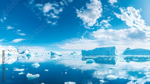 A vast expanse of icebergs floating in the crystal-clear waters of Antarctica under a bright blue sky